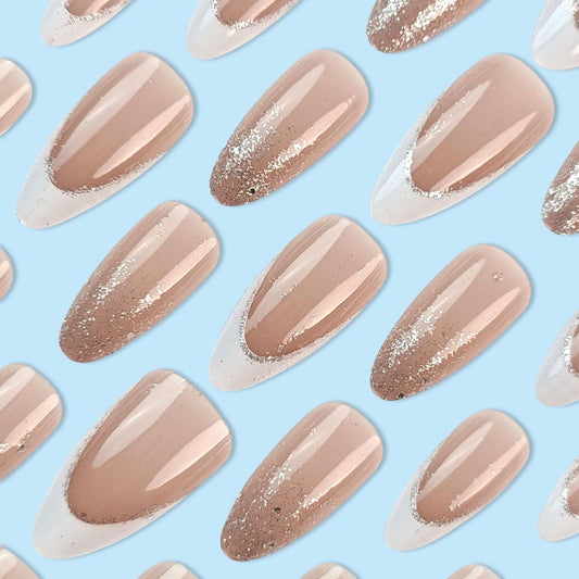 Set of nude pink press-on nails with glossy finish and glitter tip designs