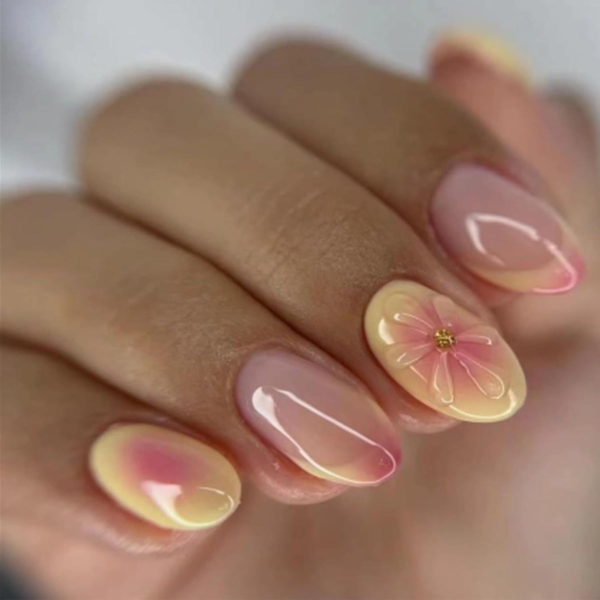 Light pink press-on nails with gradient finish and 3D flower accents
