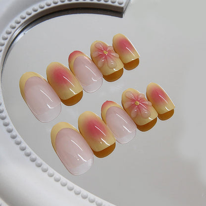 Light pink press-on nails with gradient finish and 3D flower accents