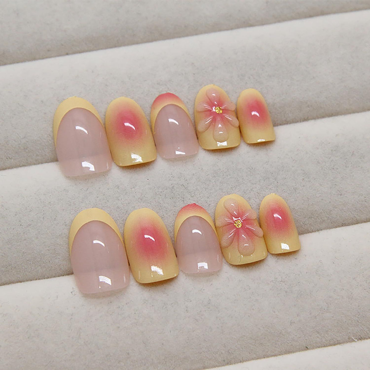 Light pink press-on nails with gradient finish and 3D flower accents
