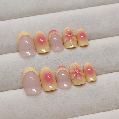 Light pink press-on nails with gradient finish and 3D flower accents