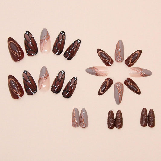 Brown medium almond press-on nails with butterfly wing designs and chrome accents