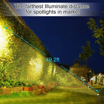 Black aluminium solar garden spotlight uplighting a tree at dusk