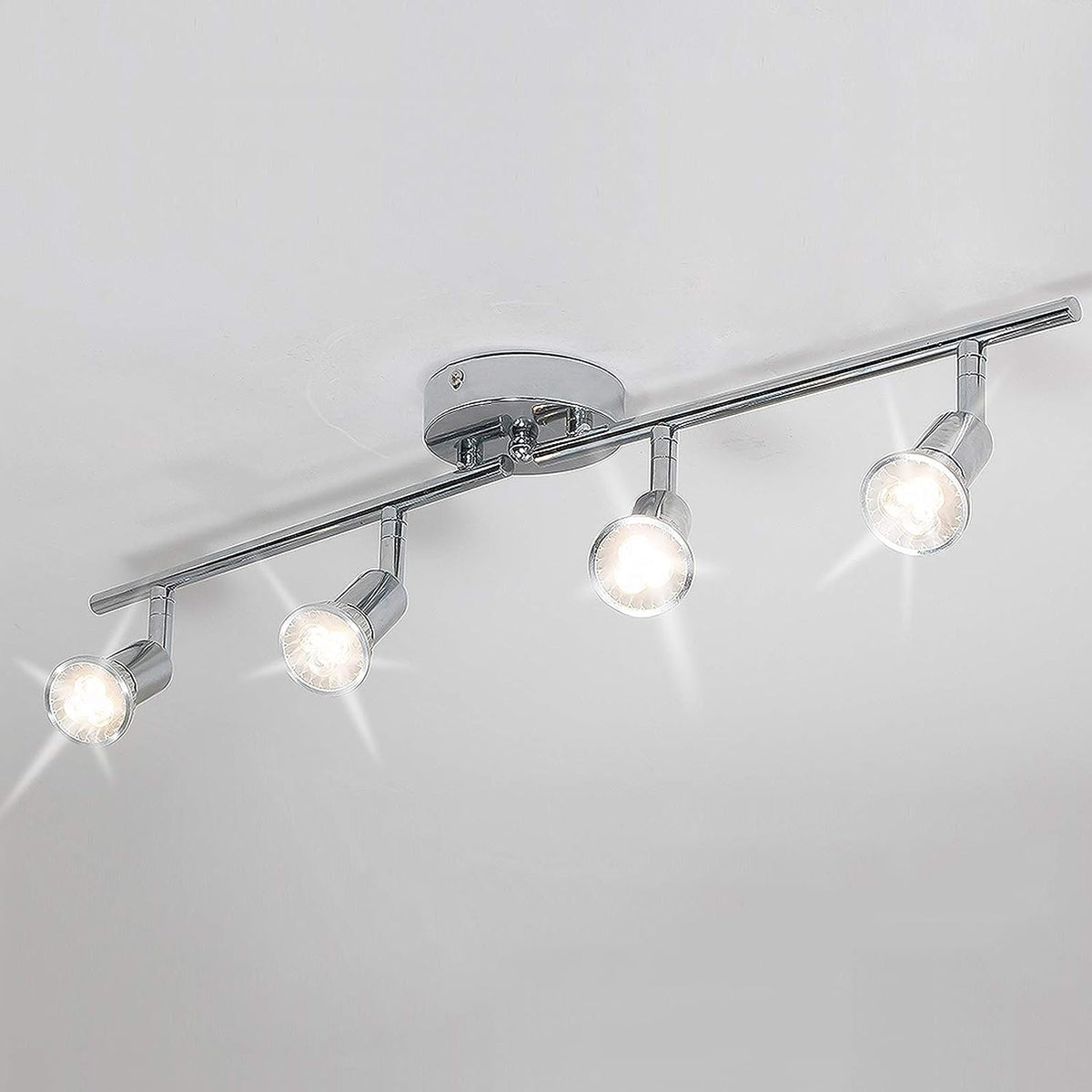 Chrome four head LED track lighting bar mounted on a ceiling