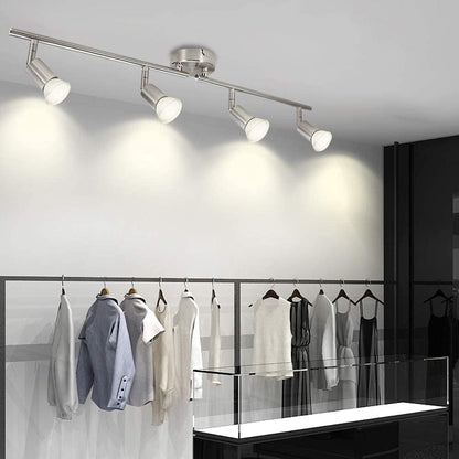 Chrome four head LED track lighting bar mounted on a ceiling