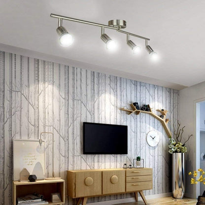 Chrome four head LED track lighting bar mounted on a ceiling
