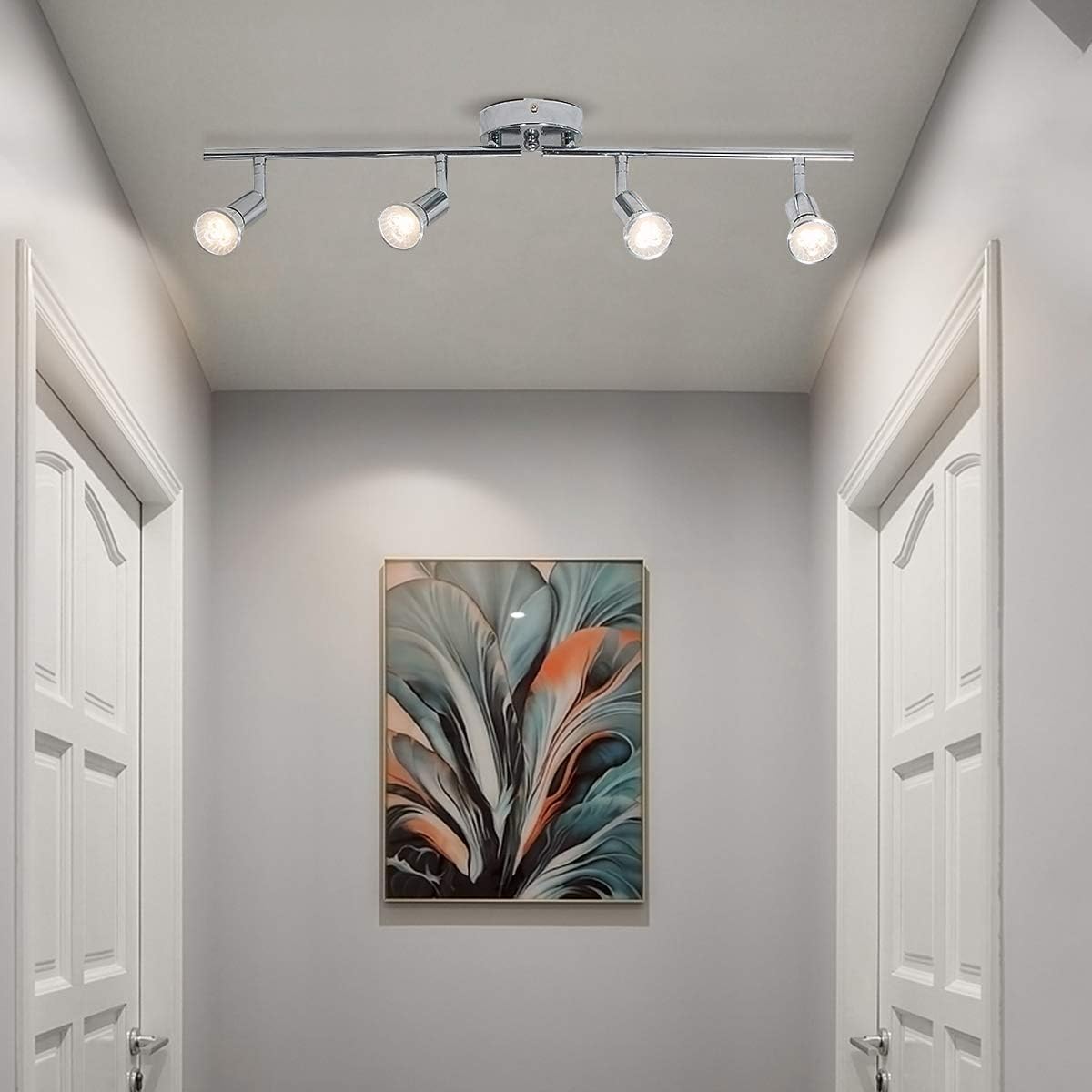 Chrome four head LED track lighting bar mounted on a ceiling