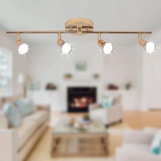 Gold four head LED track lighting bar mounted on a hallway ceiling