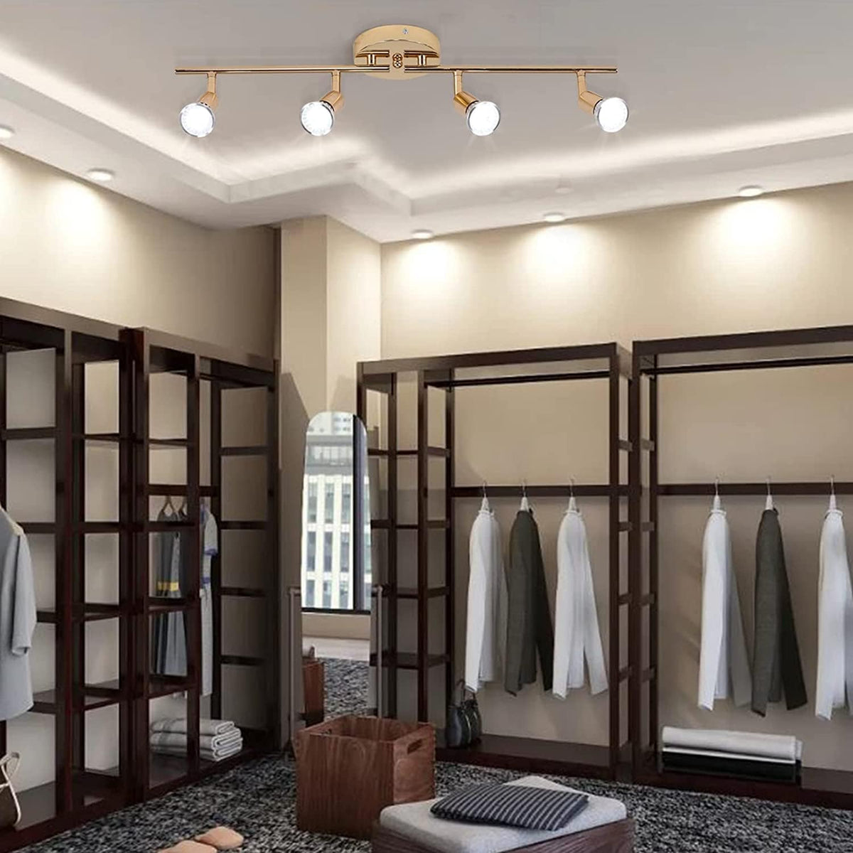 Gold four head LED track lighting bar mounted on a hallway ceiling
