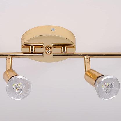 Gold four head LED track lighting bar mounted on a hallway ceiling