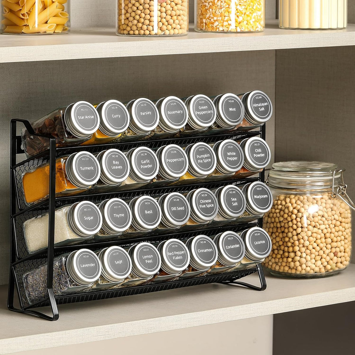 Black 4-tier spice rack with 28 clear glass jars and labels