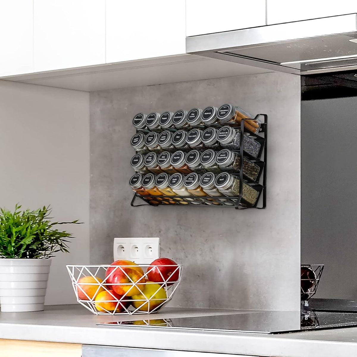 Black 4-tier spice rack with 28 clear glass jars and labels