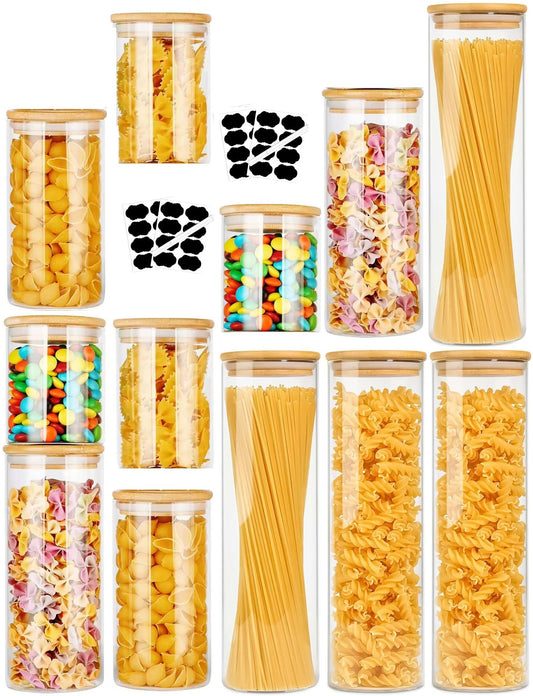 Twelve clear glass storage jars with bamboo lids in assorted sizes for pantry organisation