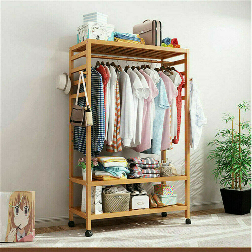 Three-tier bamboo clothes rack on wheels with side hooks and shelves