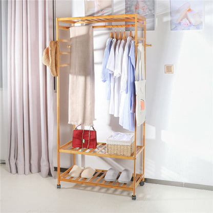 Three-tier bamboo clothes rack on wheels with side hooks and shelves
