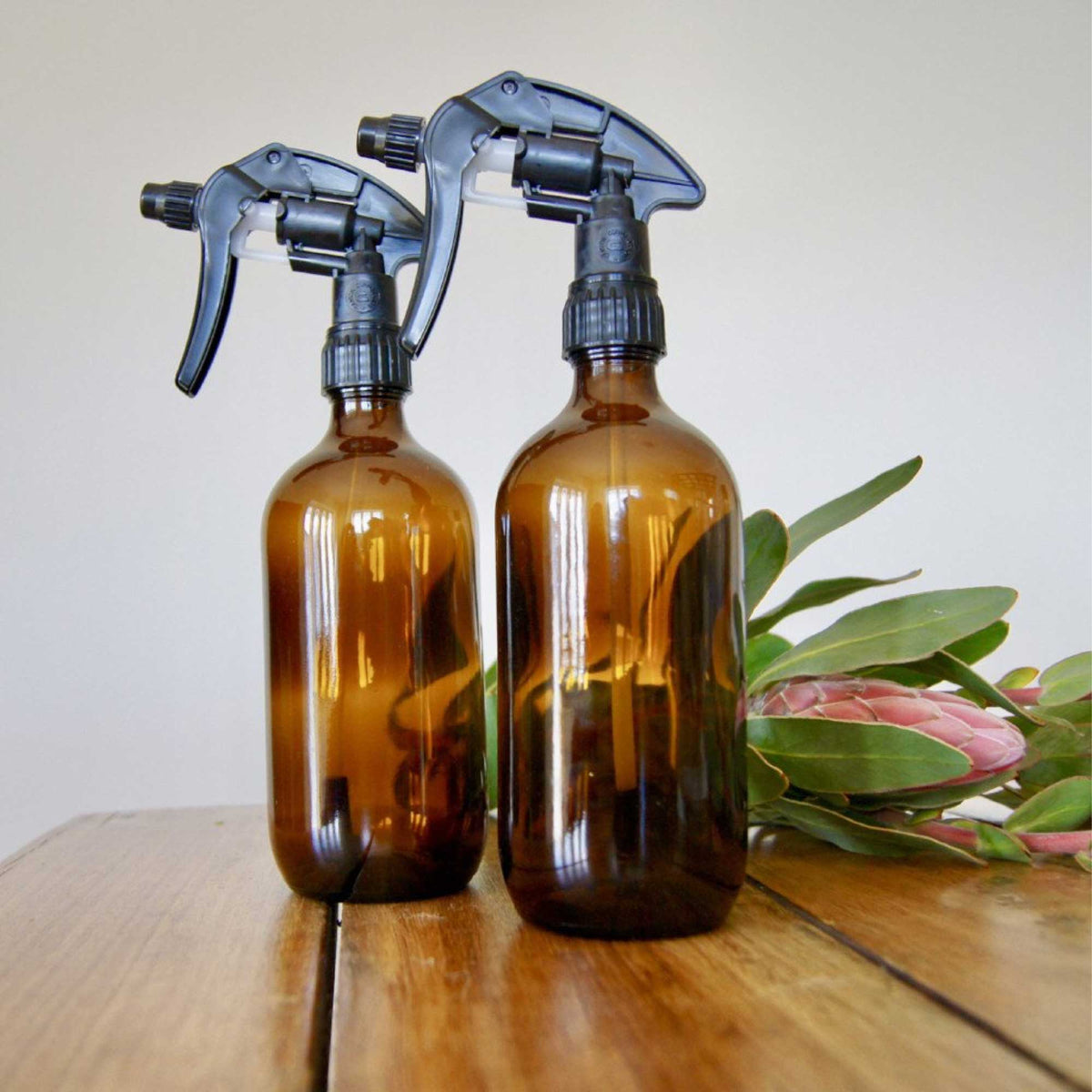 Five amber glass 500ml spray bottles with black trigger heads