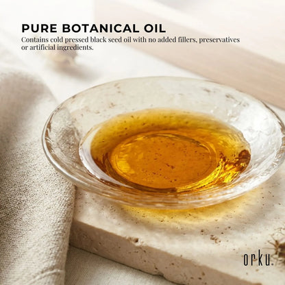 Amber bottle of Orku black seed oil shown standing upright