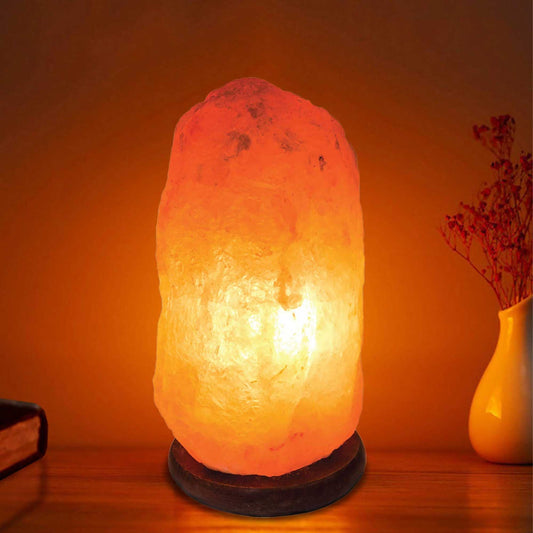Natural pink Himalayan salt lamp on a wooden base with clear bulb