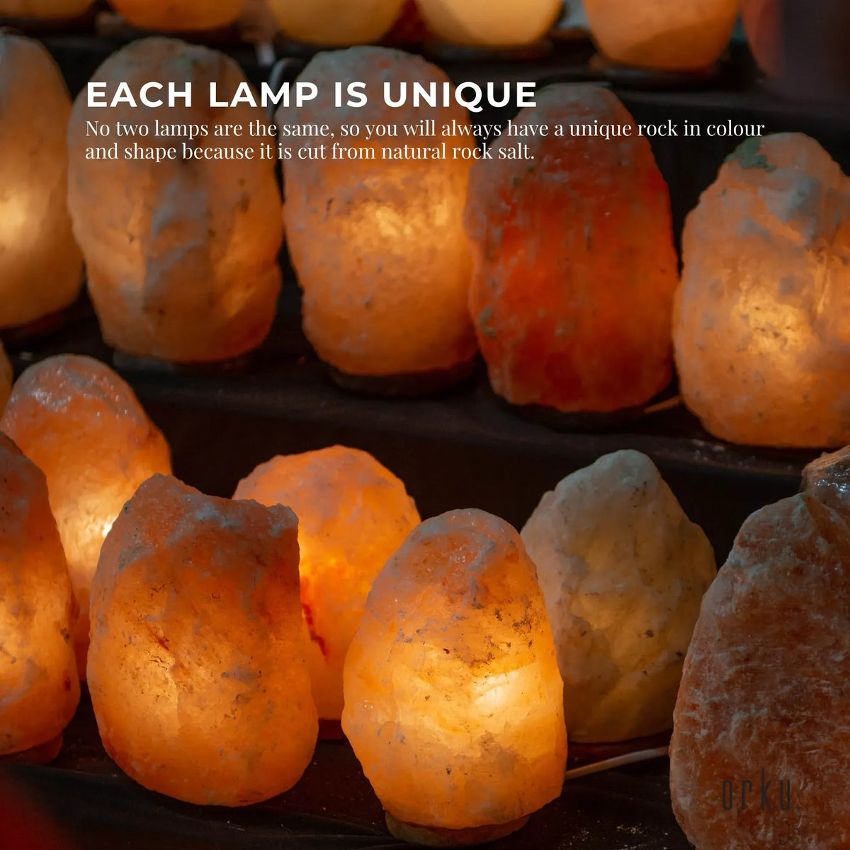 Natural pink Himalayan salt lamp on a wooden base with clear bulb