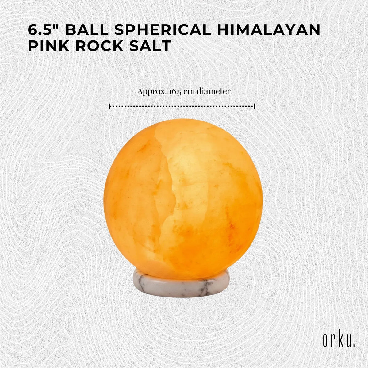 Carved sphere Himalayan pink salt lamp glowing amber on a timber base