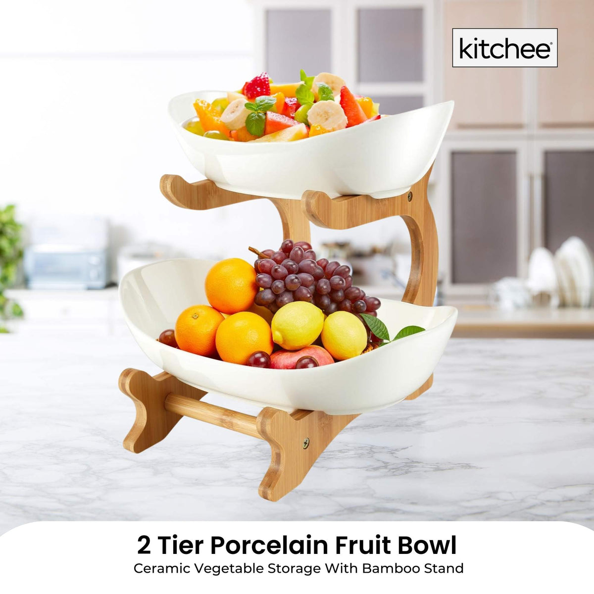 Two tier porcelain fruit bowl stand on a bamboo frame holding fruit