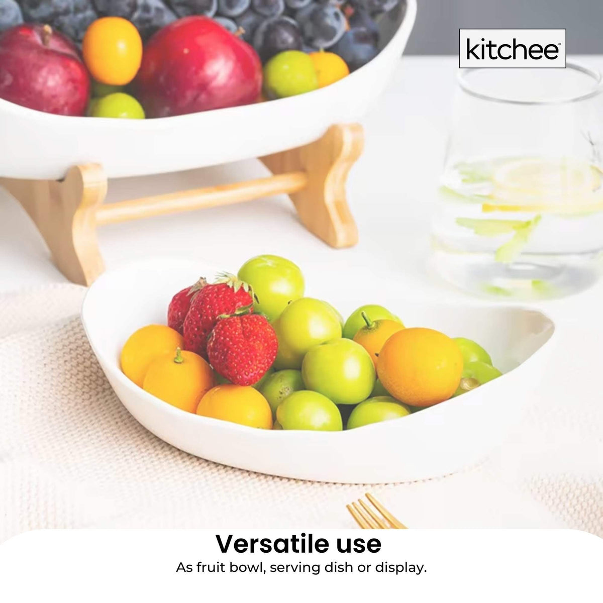 Two tier porcelain fruit bowl stand on a bamboo frame holding fruit