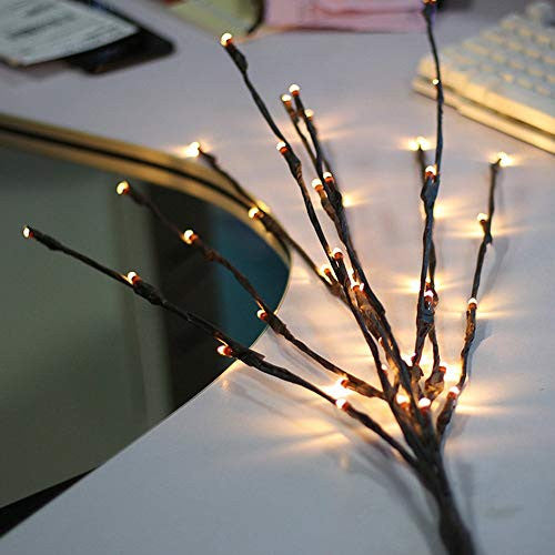 LED branch stems with warm white bulbs arranged as a table centrepiece