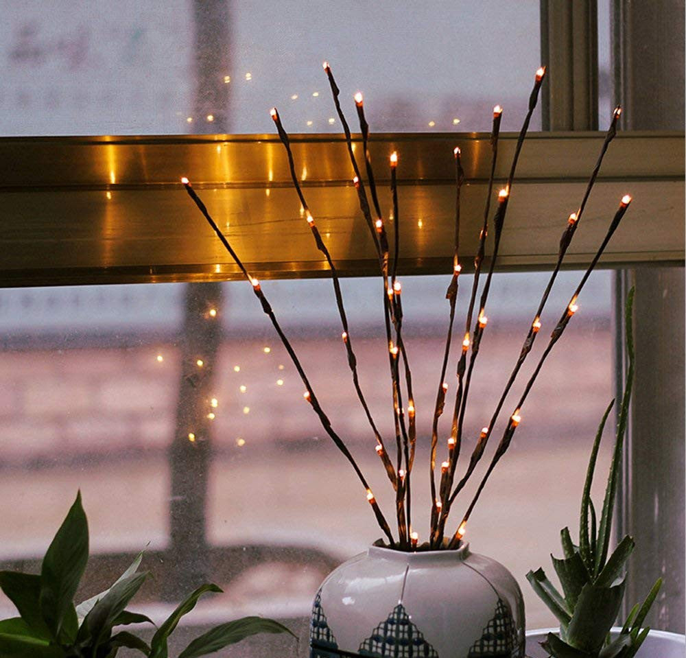 LED branch stems with warm white bulbs arranged as a table centrepiece