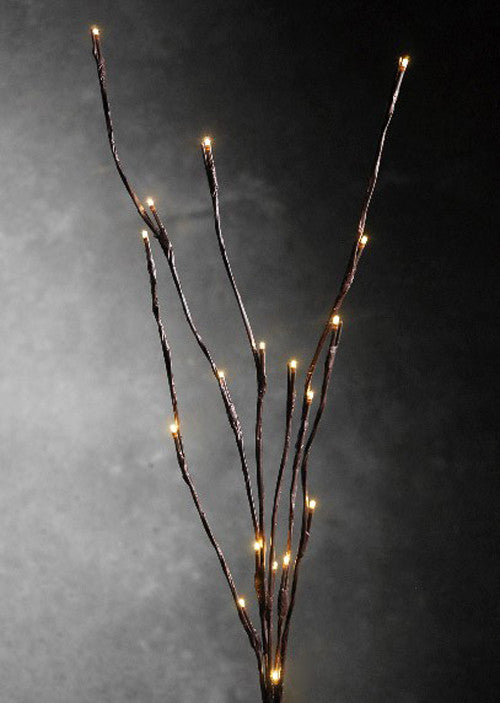 LED branch stems with warm white bulbs arranged as a table centrepiece
