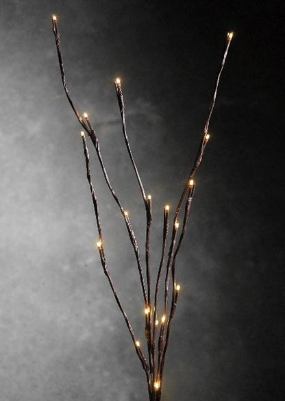 LED branch stems with warm white bulbs arranged as a table centrepiece