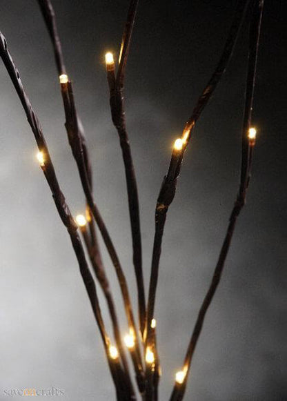 LED branch stems with warm white bulbs arranged as a table centrepiece