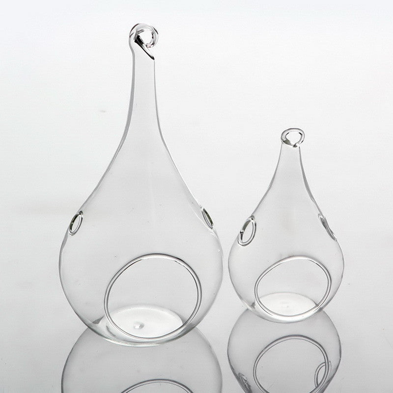 Clear glass teardrop tealight holders hanging at different heights