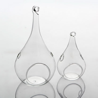 Clear glass teardrop tealight holders hanging at different heights