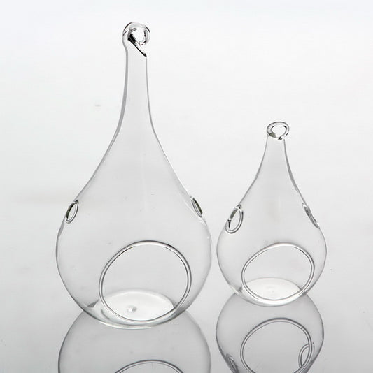 Clear glass teardrop tealight holders hanging at different heights