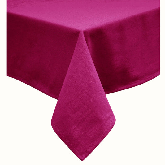 Fuchsia solid oblong table cloth laid flat on a dining table