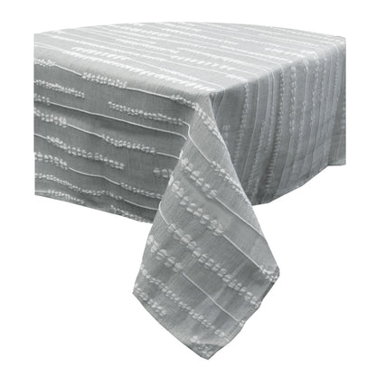 Grey and white jacquard polyester tablecloth laid over a rectangular dining table