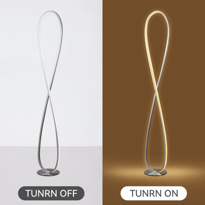Slim chrome LED floor lamp standing in a living room corner