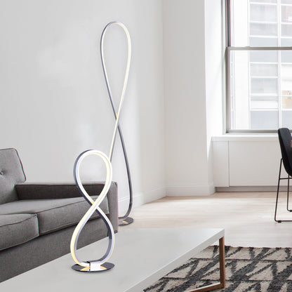 Slim chrome LED floor lamp standing in a living room corner