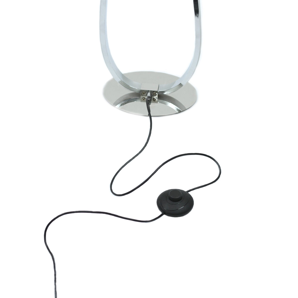 Slim chrome LED floor lamp standing in a living room corner