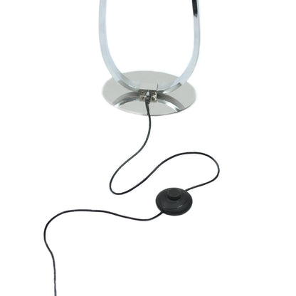 Slim chrome LED floor lamp standing in a living room corner