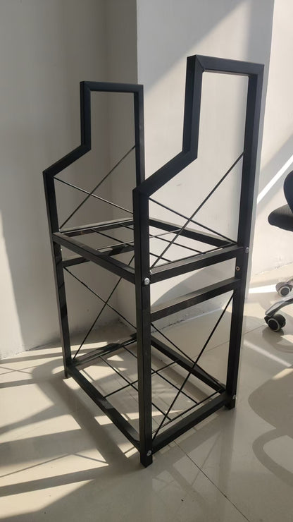 Two tier black metal firewood rack holding split logs beside a fireplace
