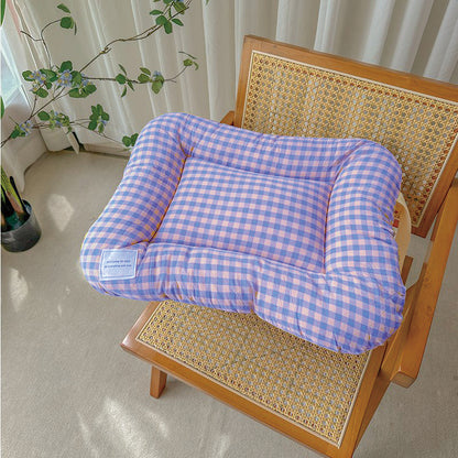 Large washable all-season pet bed in yellow and purple on a timber floor