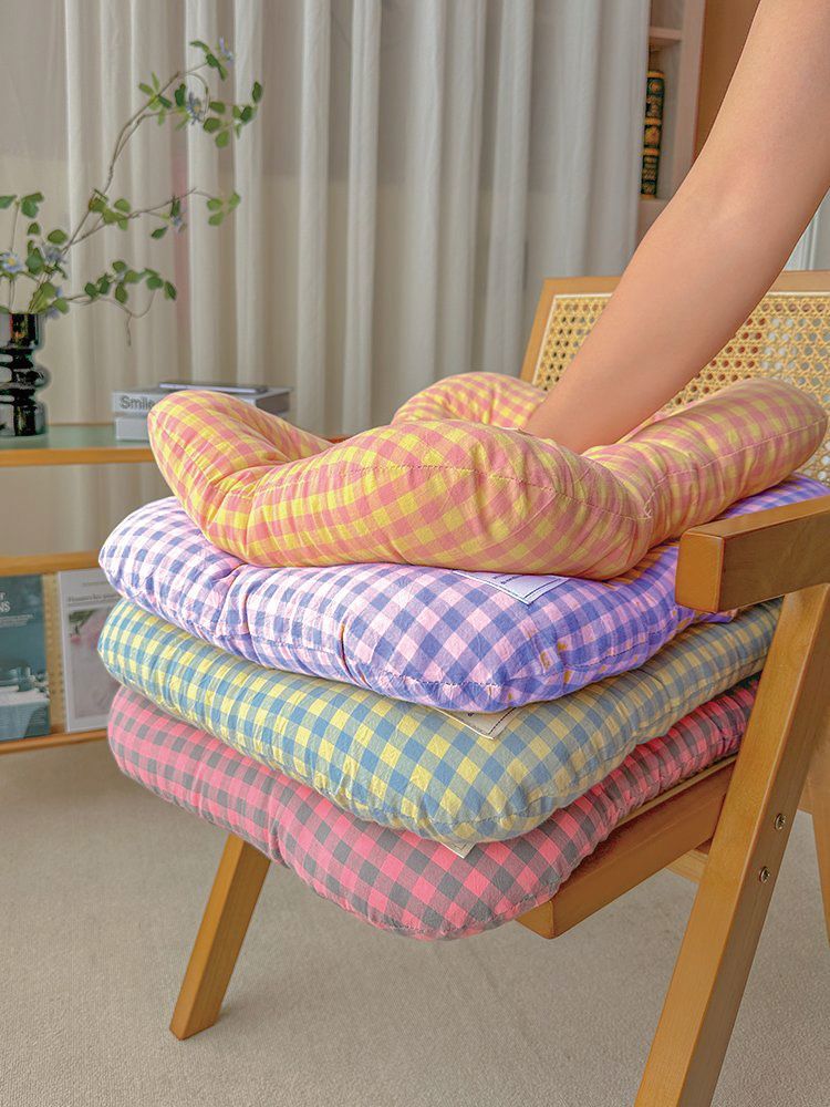 Large washable all-season pet bed in yellow and purple on a timber floor
