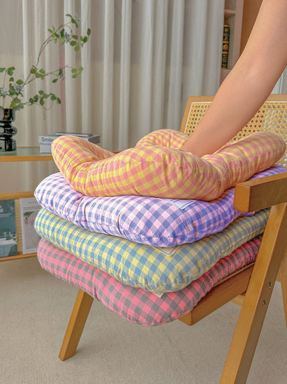 Large washable all-season pet bed in yellow and purple on a timber floor