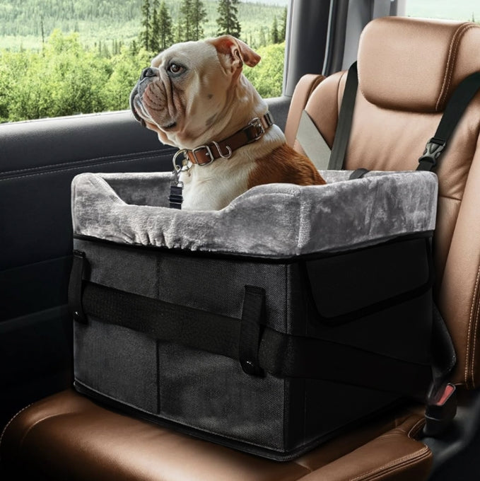 Black portable dog booster seat with plush liner, safety straps and storage pockets