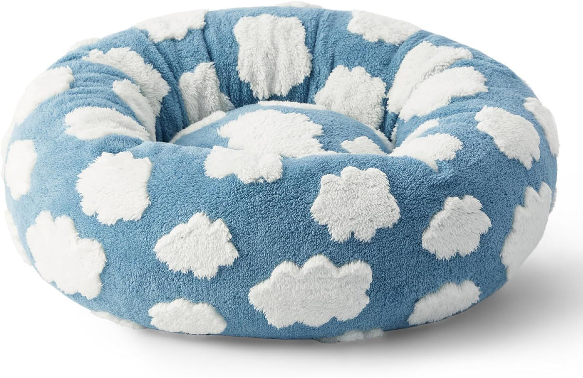 Blue round plush pet bed with white cloud pattern and raised rim