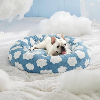 Blue round plush pet bed with white cloud pattern and raised rim