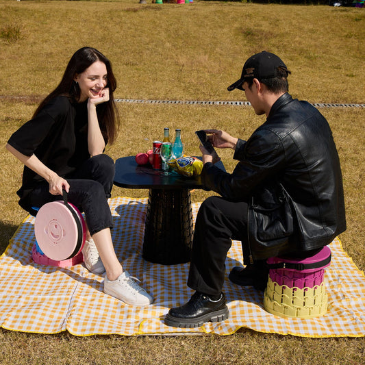 Green telescopic camping stool with wide round seat and carry strap