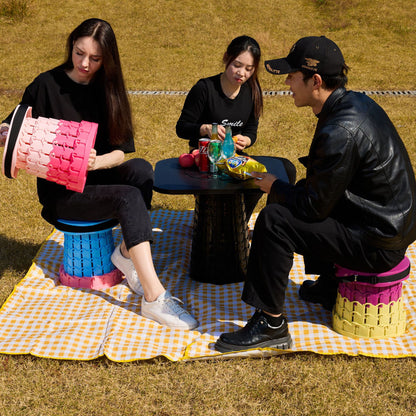Green telescopic camping stool with wide round seat and carry strap