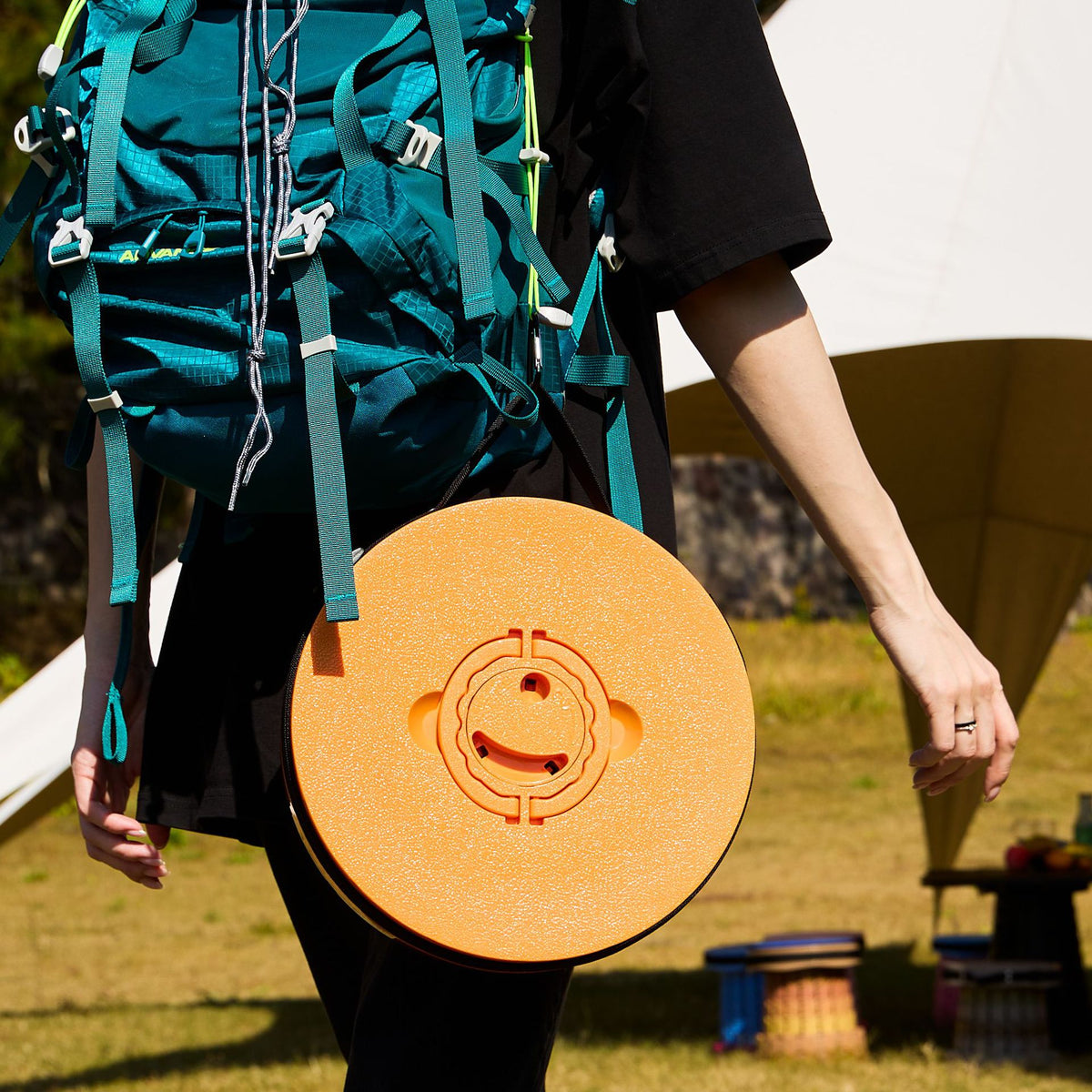 Green telescopic camping stool with wide round seat and carry strap